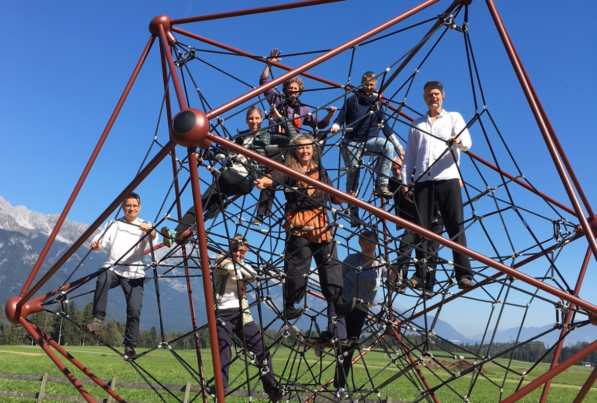 This is a photo of tai chi teachers in a web structure to celebrate the concept of community.